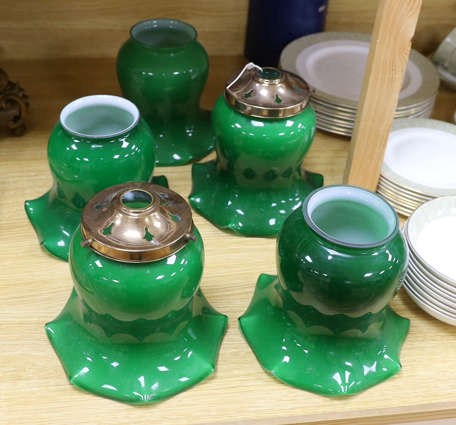 A set of five green glass shades, 18cm high